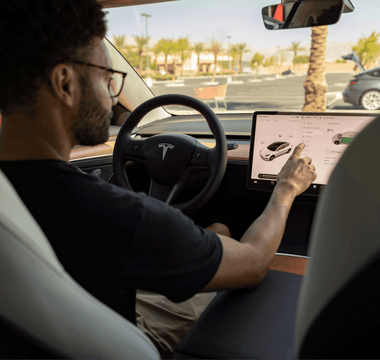 Man customizing his Tesla car with the help of his LCD screen