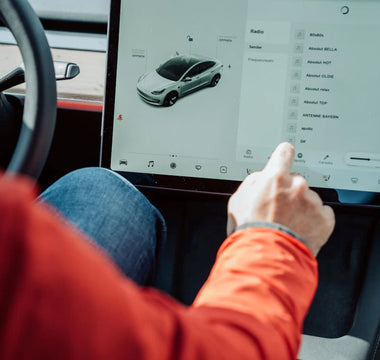 Person using the touchscreen inside a Tesla